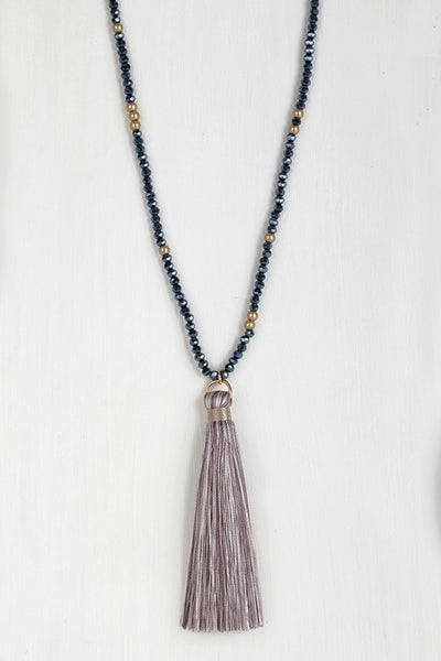 This lovely mixed glass necklace is brought to you by Urbanista. It is 32" long with a 3" extender and features a fine thread tassel pendant.