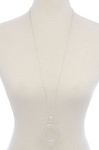 This lovely cut out circle pendant necklace from Illord is 34" long and comes in gold, rose gold, and silver.