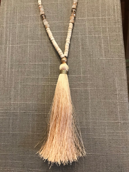 Wow! This 32 inch beaded tassel necklace adds the right icing to any top or dress. Available in Black, Grey, and Ivory.