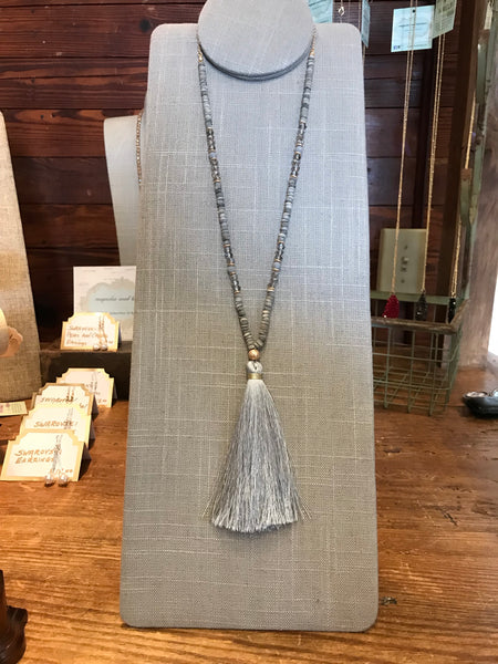 Wow! This 32 inch beaded tassel necklace adds the right icing to any top or dress. Available in Black, Grey, and Ivory.