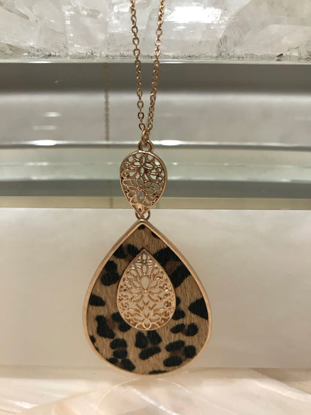 This long 33 inch necklace has a beautiful 3 1/4” inch genuine leather and faux fur animal print teardrop pendant with a filigree accent. It comes in grey embossed or brown leopard and looks great with our Ces Femme tops!