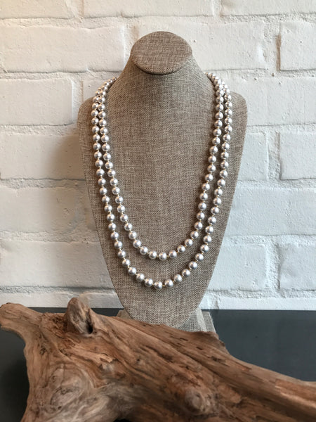 Can't get enough silver? This worn silver beaded necklace has a vintage look. It's 60 inches long and can be worn long or wrapped.