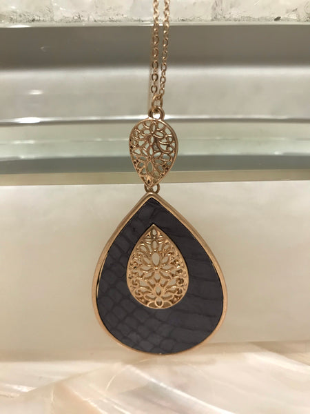 This long 33 inch necklace has a beautiful 3 1/4” inch genuine leather and faux fur animal print teardrop pendant with a filigree accent. It comes in grey embossed or brown leopard and looks great with our Ces Femme tops!