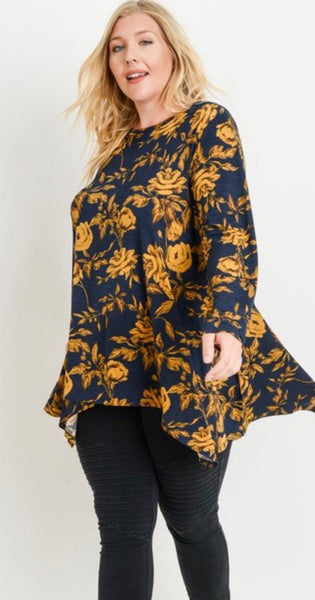 This is absolutely one of our favorite fabrics! This long sleeve round neckline top by JODIFL has a asymmetrical hem that covers all of the parts that need to be covered! The fabric is 100% polyester and just gorgeous. Available in 1X- 3X.