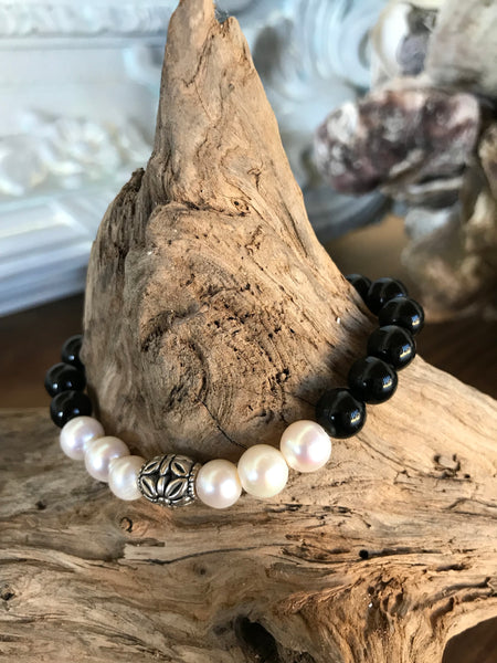 So sweet and feminine! This custom has natural pink shell beads and freshwater pearls. It's 7 inches in diameter. Great for layering with a pearl bracelet.