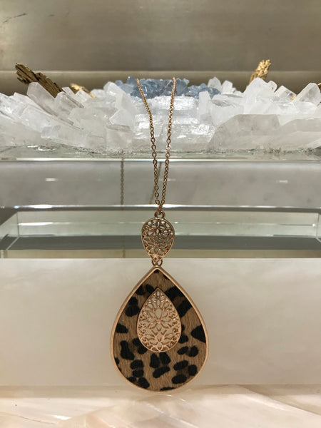 This long 33 inch necklace has a beautiful 3 1/4” inch genuine leather and faux fur animal print teardrop pendant with a filigree accent. It comes in grey embossed or brown leopard and looks great with our Ces Femme tops!