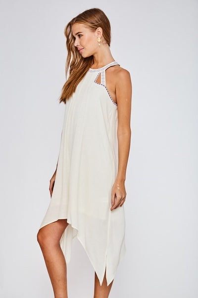 This gorgeous lined haltered neck dress from LLove features beautiful embroidered detail, an asymmetrical hem, and back button closure. Comes in Small - Large. Choose Light Coral or Off White.