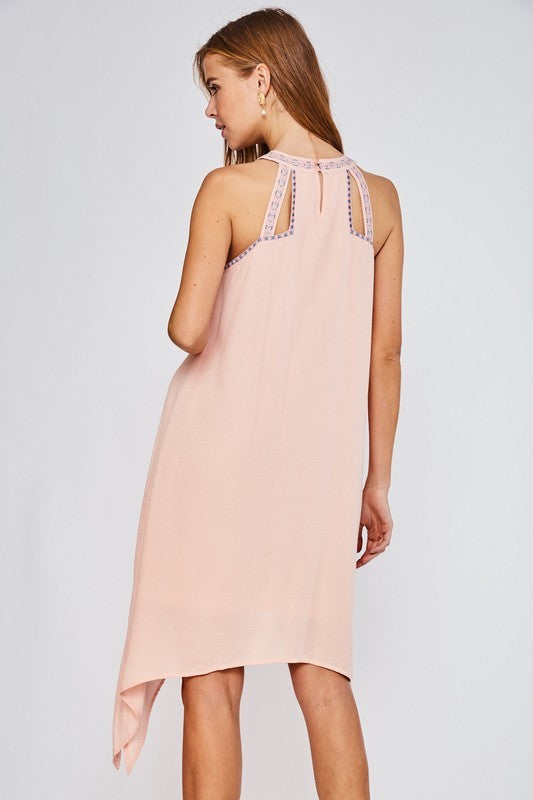 This gorgeous lined haltered neck dress from LLove features beautiful embroidered detail, an asymmetrical hem, and back button closure. Comes in Small - Large. Choose Light Coral or Off White.