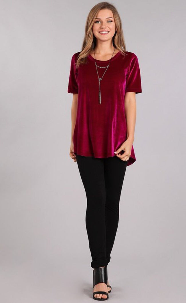 Sparkle up your day with the rose wine velvet top from Chris and Carol. So versatile and comfortable to wear to work or to your holiday function. It features a rounded neckline, short sleeves, and the back is rounded and a little lower in length than the front. Comes in small, medium, and large.