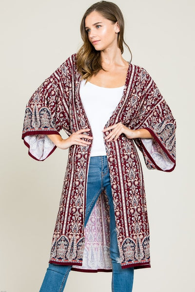 This amazing boho cardigan from Tres Bien features a relaxed fit, long length, and elegant printed fabric. Top off your favorite jeans and tee with the striking piece. 