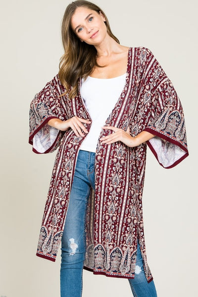 This amazing boho cardigan from Tres Bien features a relaxed fit, long length, and elegant printed fabric. Top off your favorite jeans and tee with the striking piece. 