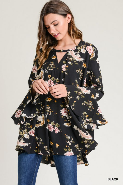 Make a statement with the floral keyhole tunic featuring a non-sheer fabric and side pockets. Model is 5'10 and wears a small. Comes in black and almond.