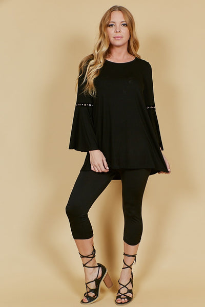 This black bell sleeve top is brought to you by Voll. It features a tunic length, round neckline, and bell sleeves with grommet detail. Comes in S, M, L, 1X, 2X, 3X. 