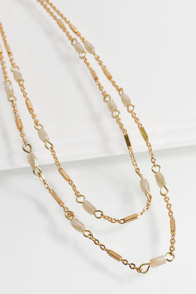 This beautiful layered chain and glass bead short necklace is by Urbanista. It features two delicate layers. Comes in Grey and Brown. 