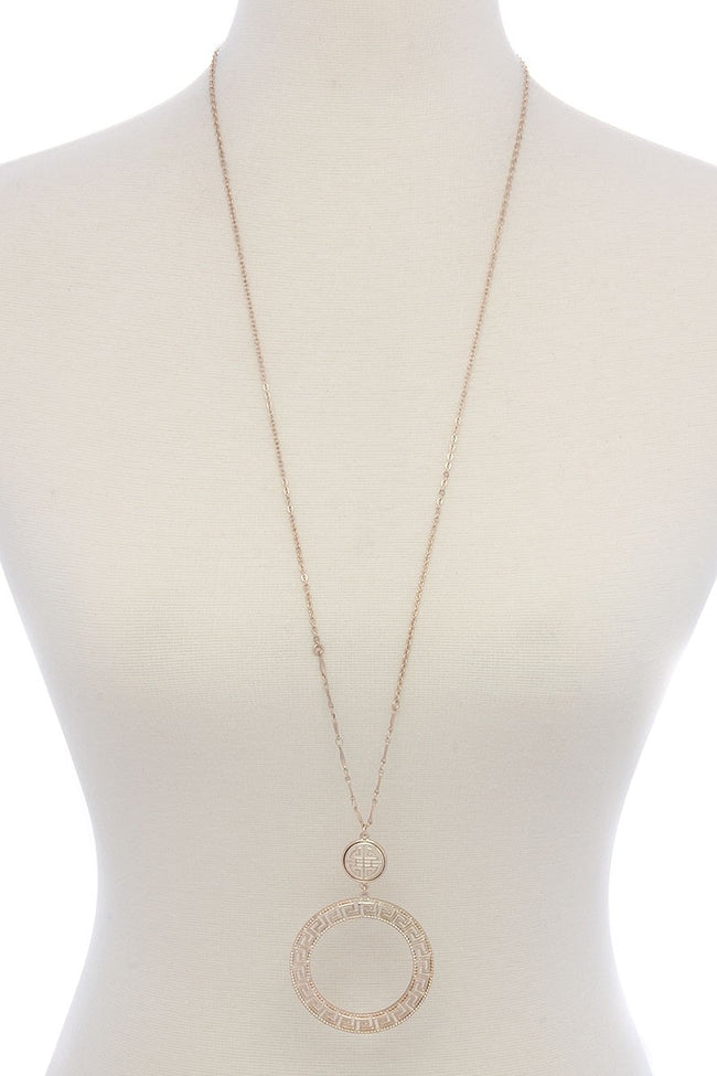 This lovely cut out circle pendant necklace from Illord is 34" long and comes in gold, rose gold, and silver.
