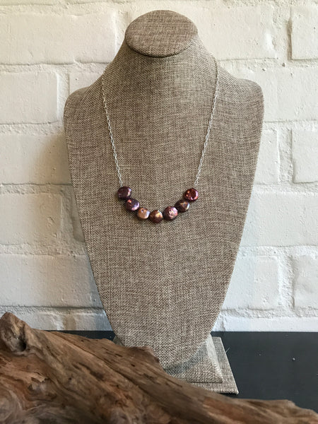 A girl's gotta love her pearls - and they are always in style. This original by Dixie Klein features 7 freshwater "coin" pearls on a silver chain. It's 23 inches in length.