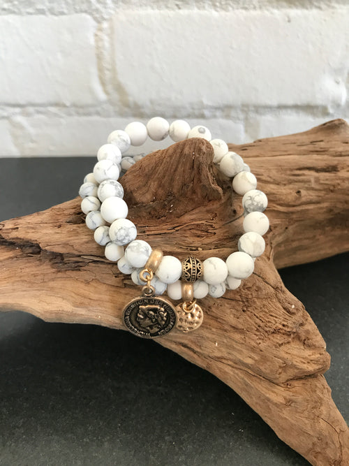 Keep it feminine with these natural frosted stone stretch bracelets. One has a coin pendant to add just a little extra.  