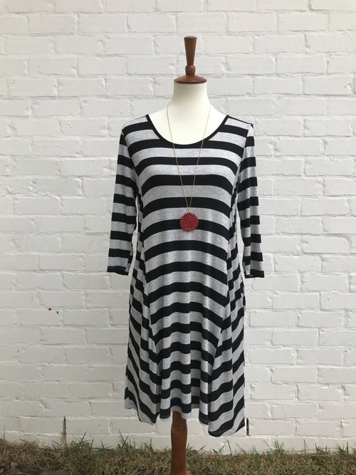 How comfy is this black and grey striped dress? It's perfect to just throw on to wear anywhere! You will feel like you are in your favorite pair of PJs, but be dressed with flair. The rounded neckline is not tight and the dress has pockets. 39 inches long. 95% rayon 5% spandex. Hand Wash. 
