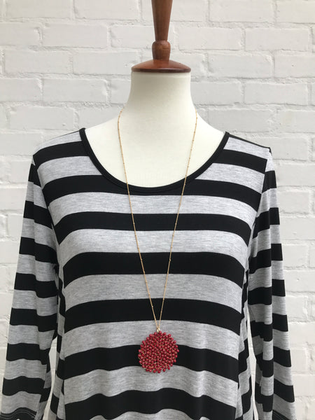 How comfy is this black and grey striped dress? It's perfect to just throw on to wear anywhere! You will feel like you are in your favorite pair of PJs, but be dressed with flair. The rounded neckline is not tight and the dress has pockets. 39 inches long. 95% rayon 5% spandex. Hand Wash. 