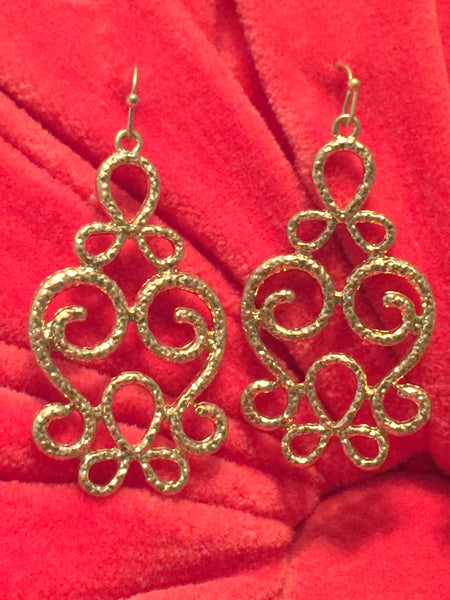 These beautiful scroll chandelier earrings compliment any outfit. They feature lovely scroll work and hang 1 and 3/4 inches. Available in silver and gold. 