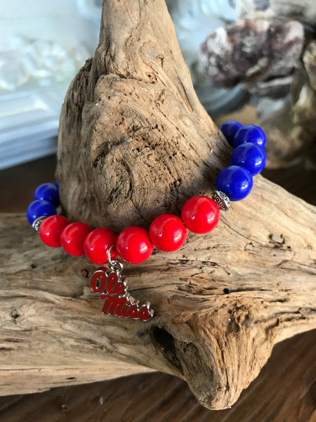 Magnolia Road Boutique brings you another custom creation with 10mm glass beads in combinations of red, white, and blue. Each bracelet features a metal and enamel Ole Miss Charm. It’s threaded on 1 mm high quality stretch cord and is approximately 7-71/4 in diameter. Wear it proudly to show your school support!  