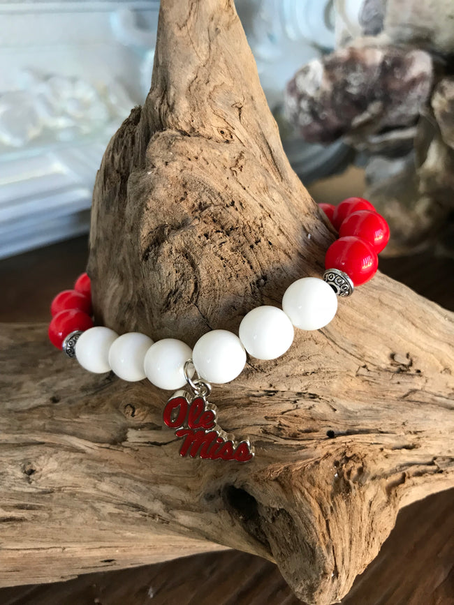 Magnolia Road Boutique brings you another custom creation with 10mm glass beads in combinations of red, white, and blue. Each bracelet features a metal and enamel Ole Miss Charm. It’s threaded on 1 mm high quality stretch cord and is approximately 7-71/4 in diameter. Wear it proudly to show your school support!  