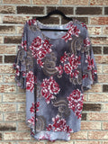 This grey and burgundy floral top from Honeyme is a loose fitting tunic length with a beautiful, rich floral pattern. It features a ruffle detail on the elbow sleeve and a round neck. Comes in 1X-3X. Absolutely gorgeous!