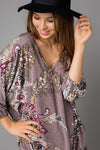 This lovely tunic top by Lovely J features a relaxed fit, V-neck, and front tie detail. Comes in Small - 3X.
