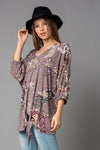 This lovely tunic top by Lovely J features a relaxed fit, V-neck, and front tie detail. Comes in Small - 3X.
