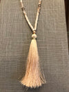 Wow! This 32 inch beaded tassel necklace adds the right icing to any top or dress. Available in Black, Grey, and Ivory. 