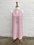 She & Sky created this soft sleeveless dress perfect for a shower or party. The neckline is high with a keyhole and the back has a single fabric covered button. The length on a medium is 36 inches and the dress is fully lined. Available in soft pink or off white. 70% Cotton/30% Polyester.   Fits true to size: Small 2/4, Medium 6/8, Large 10/12