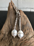 These Swarvorski drop pearl earrings with inlaid crystals are THE perfect finish to any outfit. Available in gold or silver, the 2 inch length will show off the large pearl with inlaid crystals. 
