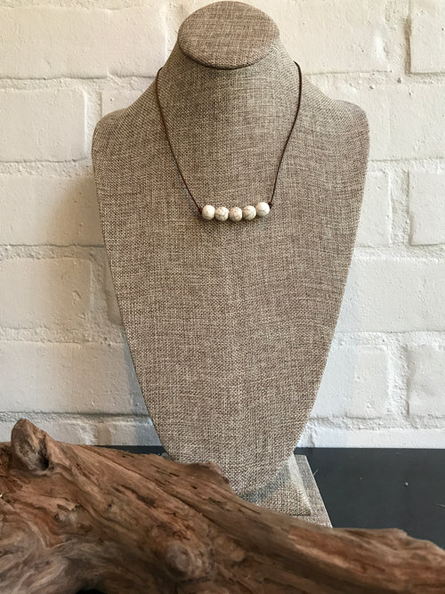 Custom designed amazonite natural stone necklace by Dixie Klein. It's 19 inches long with black leather. We love this with any of our swing dresses - just the right pop of color.