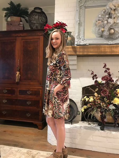 This animal paisley print criss-cross pocket dress with ruffle sleeve detail is amazing. It is wrinkle free so forget about ironing! Pair it with our black or sage velvet vest found on our Tops Collection.