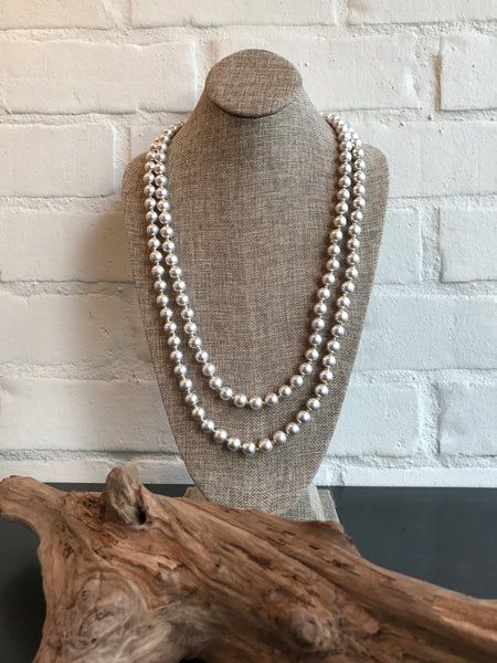 Can't get enough silver? This worn silver beaded necklace has a vintage look. It's 60 inches long and can be worn long or wrapped. 