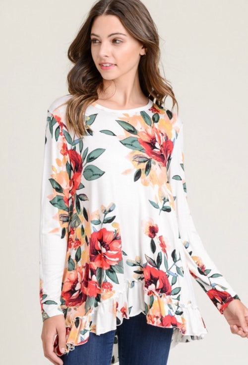 This white floral top by Jodifl has a beautiful floral print, long sleeves and a ruffled hem. Pair it with jeans or leggings for a cute look. 95% rayon and 5% spandex.  Fits true to size: Small 2/4, Medium 6/8, Large 10/12