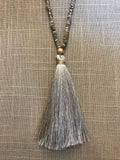 Wow! This 32 inch beaded tassel necklace adds the right icing to any top or dress. Available in Black, Grey, and Ivory. 