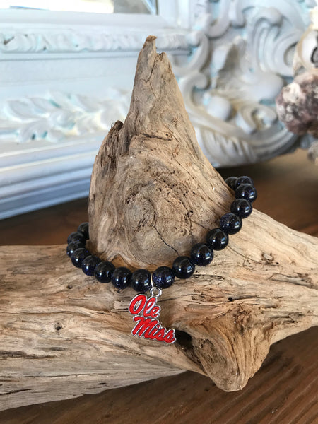 Magnolia Road Boutique brings you our own custom creation with red and blue natural stone beads.  It’s threaded on 1 mm high quality stretch cord and has an Ole Miss charm in enamel. Wear it proudly to show your school support!  