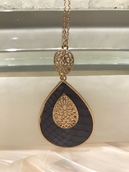 This long 33 inch necklace has a beautiful 3 1/4” inch genuine leather and faux fur animal print teardrop pendant with a filigree accent.  It comes in grey embossed or brown leopard and looks great with our Ces Femme tops! 