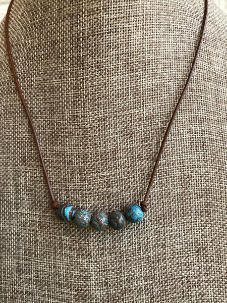Beautiful blues and browns are highlighted in this natural 5 stone jasper necklace with brown leather created by Dixie Klein. Length - 17 inches