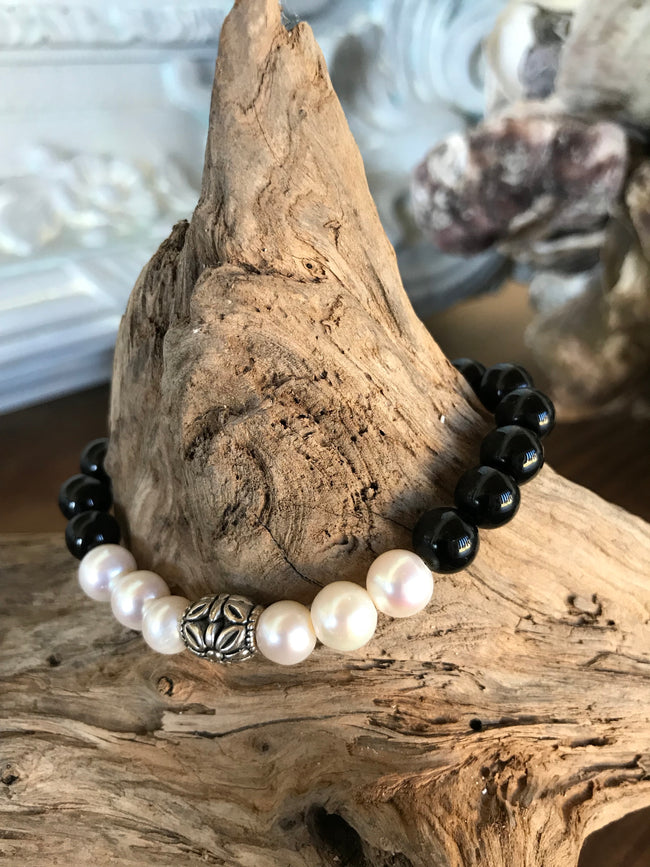 So sweet and feminine! This custom has natural pink shell beads and freshwater pearls.  It's 7 inches in diameter. Great for layering with a pearl bracelet. 