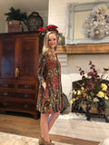 This brick red and taupe paisley dress with suede crisscross accents is truly a gem. The colors are deep and rich - shades of red and taupe mixed with highlights of gold, black, brown and blue mix perfectly to create this elegant Honeyme dress. Wear it with boots and you are done! 40 inches long. 96% polyester 4% spandex. Pockets. Hand Wash. 