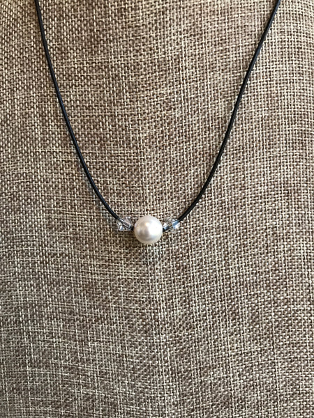 Simple and elegant pearl and leather necklace by Dixie Klein. Large natural freshwater pearl Swarovski crystal on black leather. This beauty is 20 inches long. 