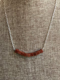 A unique brown gold stone necklace with square beads. This piece was handcrafted by our own Dixie Klein. It's 20 inches. 