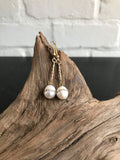 These Swarvorski drop pearl earrings with inlaid crystals are THE perfect finish to any outfit. Available in gold or silver, the 2 inch length will show off the large pearl with inlaid crystals. 
