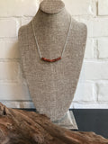 A unique brown gold stone necklace with square beads. This piece was handcrafted by our own Dixie Klein. It's 20 inches. 