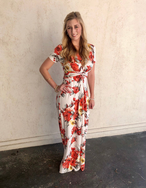 Gorgeous shades of coral and  goldenrod adorn this off white short sleeved maxi dress.  The material is buttery soft!  It has a v-neck line and is gathered at the waist for an elegant look.  Fall weddings or a night out says yes to this dress!