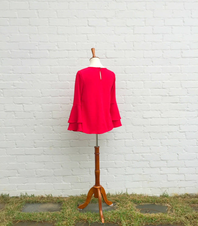 This elegant red blouse is perfect for holiday parties and family gatherings. It has a round neckline with double bell sleeves. Wear it with our layered freshwater pearl and Celtic symbol necklace found in our accessories collection.﻿
