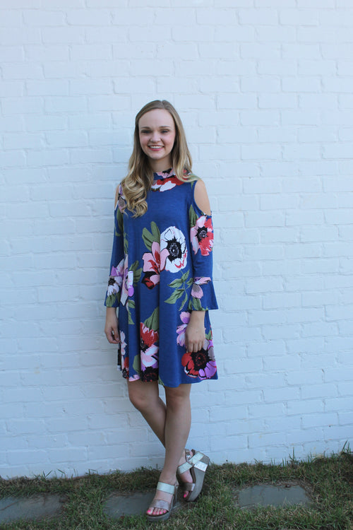 Only a limited number of this blue floral dress is available. The color combinations and cold shoulder dress will turn heads at work or at the game. 