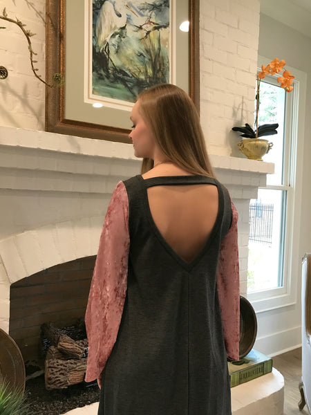 This dress combines causal charcoal knit with updated velvet pink sleeves. It is an original look and super comfortable. Dress it up or down with the perfect necklace found in accessory collection.